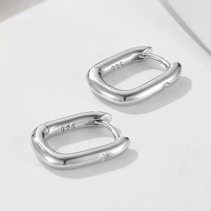Detail of 925 sterling silver earring with engraved hallmark and crystal accent