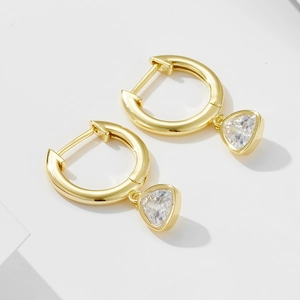 Macro detail showing S925 hallmark on gold plated geometric triangle zircon earrings