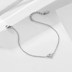 925 sterling silver heart bracelet with star-etched zircon on a white geometric stage