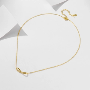 Close-up of golden S925 silver infinity pendant necklace with cubic zirconia detailing