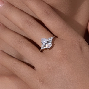 Pear cut 5A zircon S925 sterling silver ring worn on hand showing cluster details