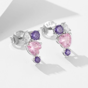 Macro shot of S925 sterling silver studs with heart-shaped pink and purple zircons