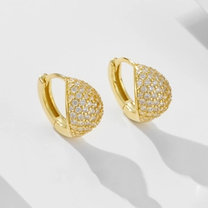 Detail of gold teardrop hoop earrings with micro pavé cubic zirconia on geometric steps