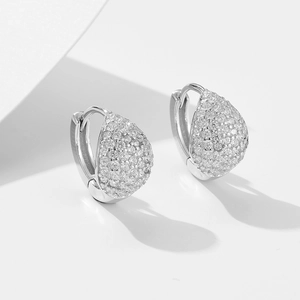 Macro shot of silver S925 sterling silver hoop earrings with pave-set cubic zirconia stones
