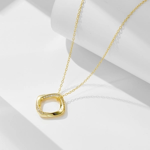 Détail d'un collier géométrique carré plaqué or avec des pierres de zircon scintillantes