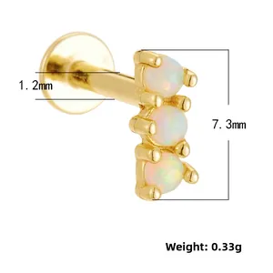 Detailed macro view of 1.2mm gold labret stud with three vertical white opal stones