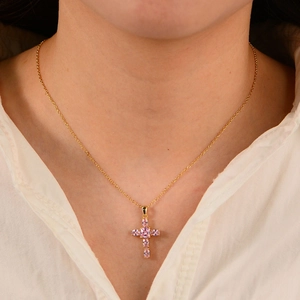 Elegant gold S925 silver necklace featuring a pink zircon cross pendant on female model
