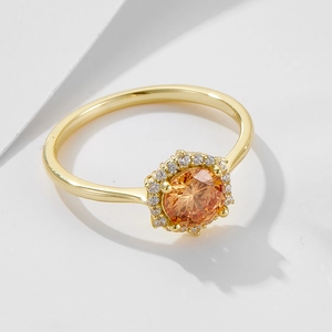 Dettaglio dell'anello con zircone champagne, fascia dorata e accenti luminosi