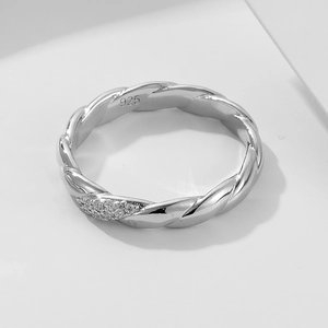 Macro view of S925 sterling silver braided ring featuring sparkling pave zircon details