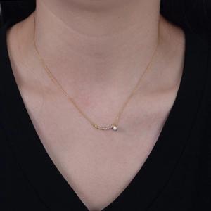 Elegant gold sterling silver necklace with curved diamond pendant and white pearl charm