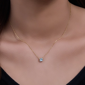 Elegant 925 silver gold necklace featuring a square light blue topaz pendant on model