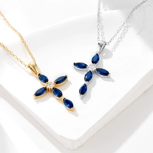 Luxurious sterling silver cross necklaces with blue zircon marquise stones in gold and silver