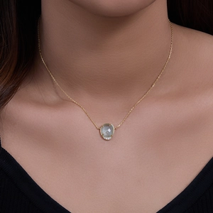 Elegant 18K gold-plated necklace with oval green gemstone and diamond accents