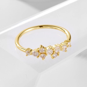 Macro detail of gold-plated 925 silver ring with sparkling cubic zirconia clusters