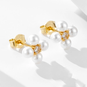 Detailed macro view of S925 silver flower earrings with pearls and zircon center