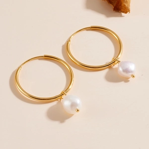 Minimalist S925 silver gold hoop earrings with natural freshwater pearls on a beige surface