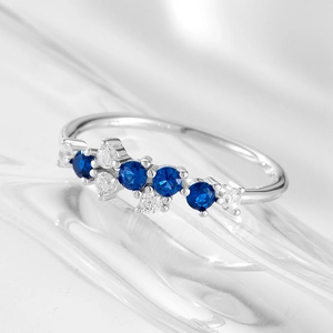 Close-up of S925 sterling silver ring featuring four round blue stones and clear zircons