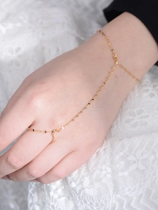 Detail view of 925 silver gold hand harness with ring and tile chain on lace
