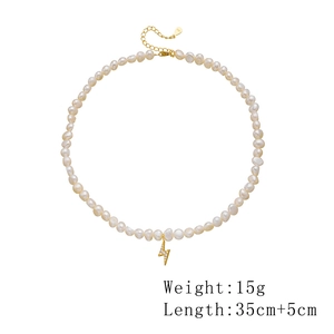 Detail of freshwater pearl necklace with gold lightning bolt pendant and s925 silver clasp