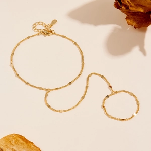 Detail of S925 sterling silver gold finger bracelet with delicate chain and round discs