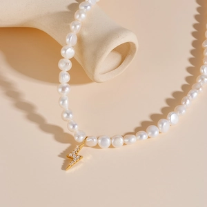 Elegant freshwater pearl necklace featuring a gold lightning bolt pendant with zircon