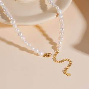 Detail of freshwater pearl necklace with 925 sterling silver clasp on ceramic plate