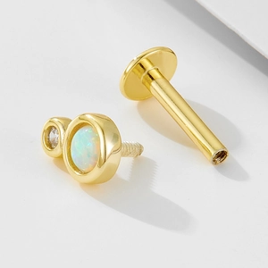 Macro detail of 925 silver opal labret stud with threaded post and gold plating