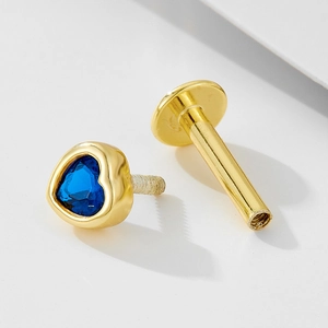 Macro view of 925 silver screw back earring featuring a blue heart-shaped opal stone