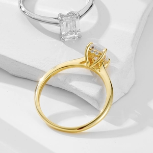Macro detail of emerald cut rectangular zircon ring in gold and silver finish on stone