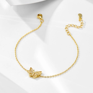 Close-up of gold butterfly pendant bracelet with pave-set crystals and adjustable chain