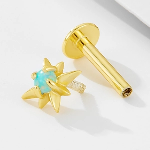 Macro shot of 925 silver gold-plated opal star labret stud with internal threading