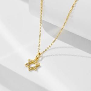 Detail of 14k gold plated star pendant necklace with sparkling zircon pavé and ball edge