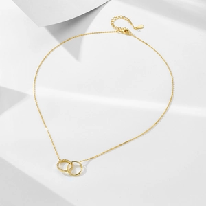 Detail of interlocking gold double circle pendant with pavé cubic zirconia on S925 silver chain