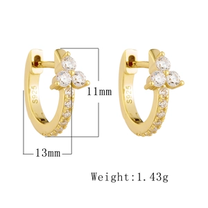 Macro shot of 925 sterling silver gold hoop earrings with cubic zirconia cluster details