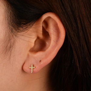 Elegant S925 silver cross stud earrings with sparkling pavé crystals worn on ear