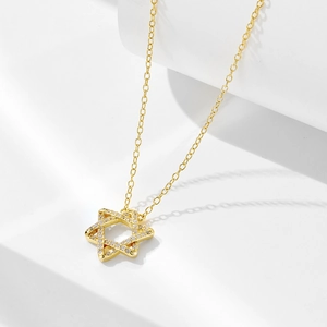 Detail view of a gold S925 silver star pendant necklace with cubic zirconia micro-inlay