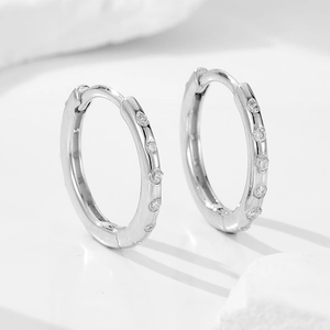 S925 sterling silver geometric hoop earrings with diamonds on white marble stone