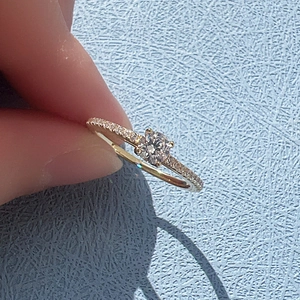 Detailed shot of an S925 silver pave ring featuring a brilliant round center diamond stone