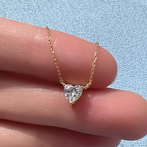 Detail of s925 sterling silver heart-shaped zircon pendant necklace on a classic cable chain