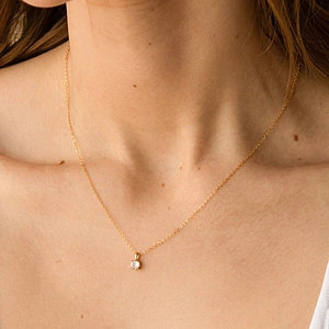Elegant 925 sterling silver four-prong round zircon pendant necklace on female model