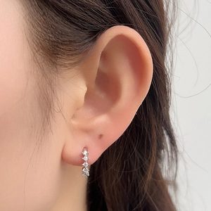 Close-up of S925 sterling silver C-shaped hoop earrings with five sparkling zircon stones