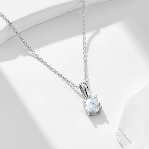 Minimalist 925 sterling silver four-prong round zircon necklace on a textured stone base