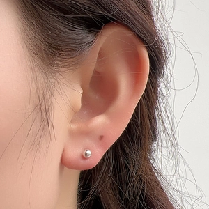 Minimalist S925 sterling silver round bead stud earrings worn by model on earlobe