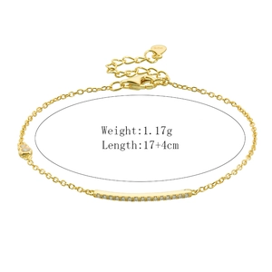 Macro detail of 925 silver gold bracelet featuring paved cubic zirconia bar and logo charm