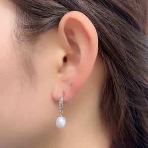 Close-up of S925 silver long hook earring featuring a lustrous freshwater pearl with zircon