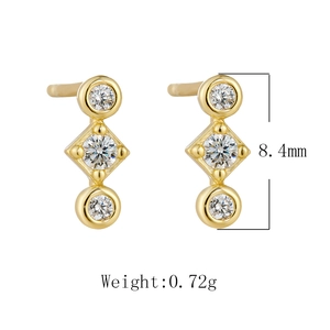 Detailed view of geometric vertical earrings with three sparkling round zircons in gold