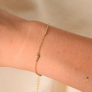 Detail of adjustable gold S925 silver chain bracelet with round bezel-set and pavé diamonds