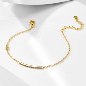 Detail of s925 silver gold bracelet featuring a crystal-set bar and heart-shaped charm
