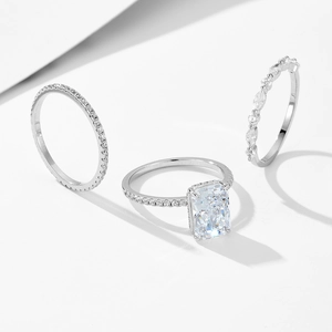 Macro detail of three-piece silver ring set with ice-cut zircon and geometric shadows