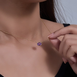 Macro view of rectangular purple amethyst pendant with gold plated sterling silver chain